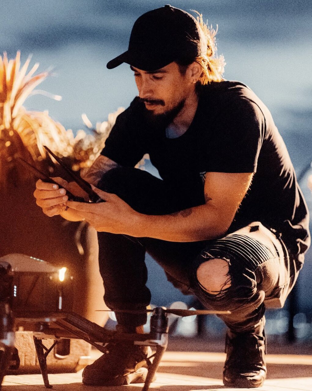 Tim McCartney setting up a drone at dusk