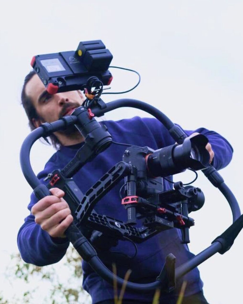Tim McCartney carrying a camera gimbal on location