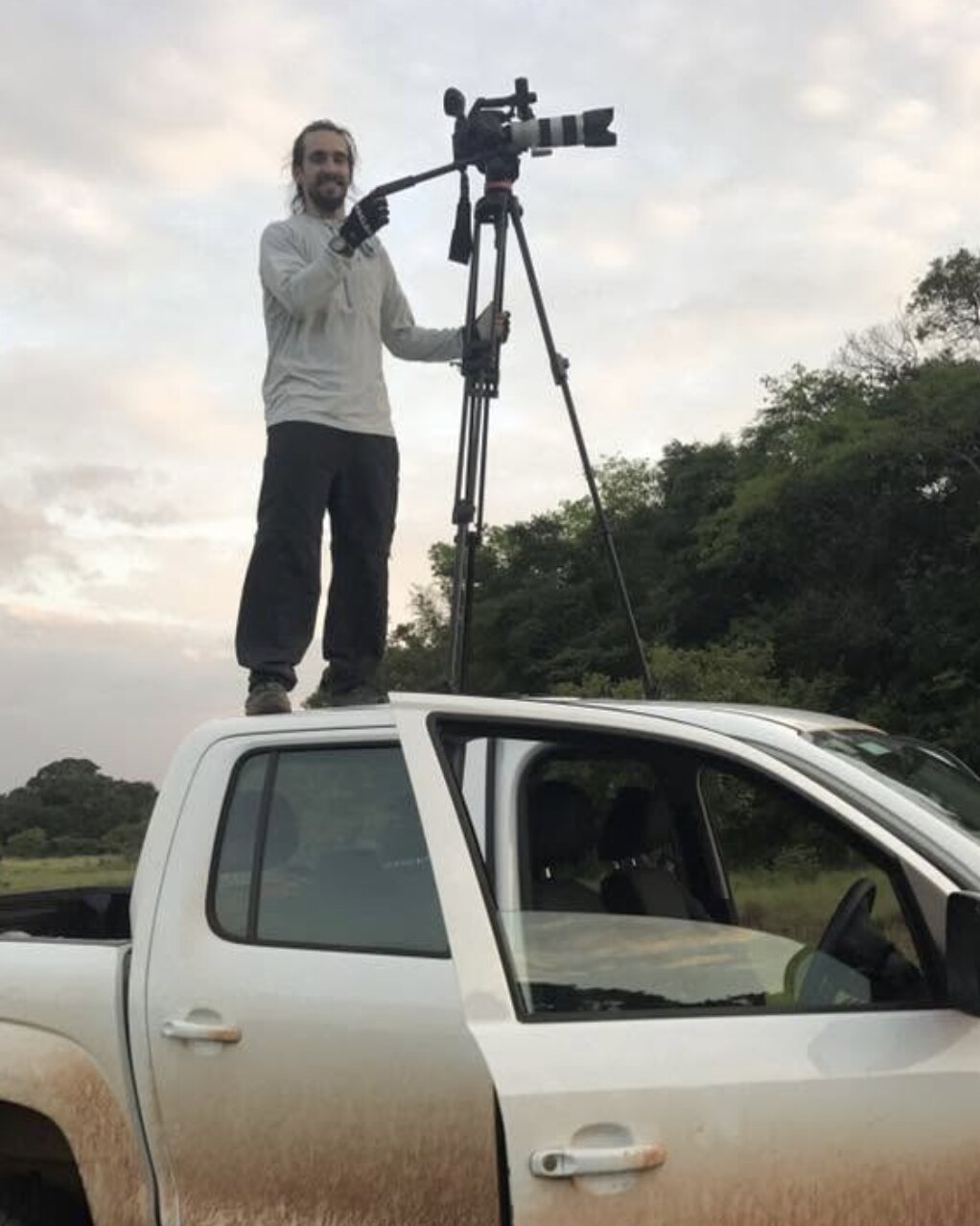 Tim McCartney filming from the roof of a ute with a tripod and long lens